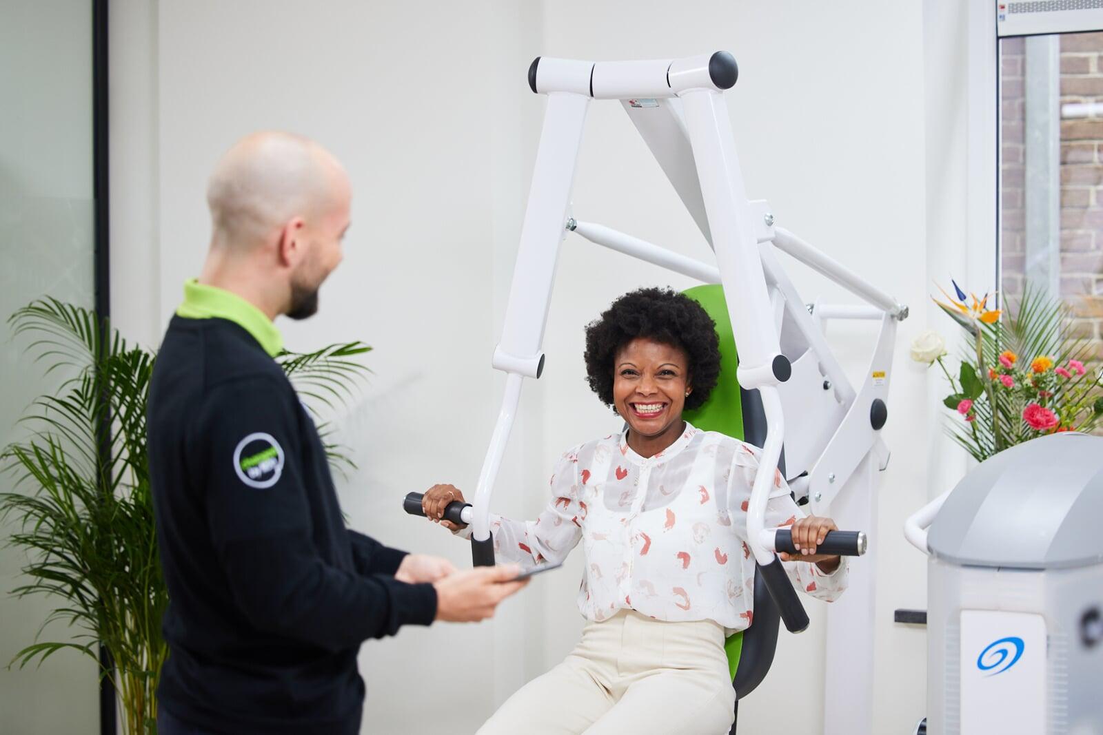 Lachende fit20'er op de fit20 apparatuur in de rustige studio